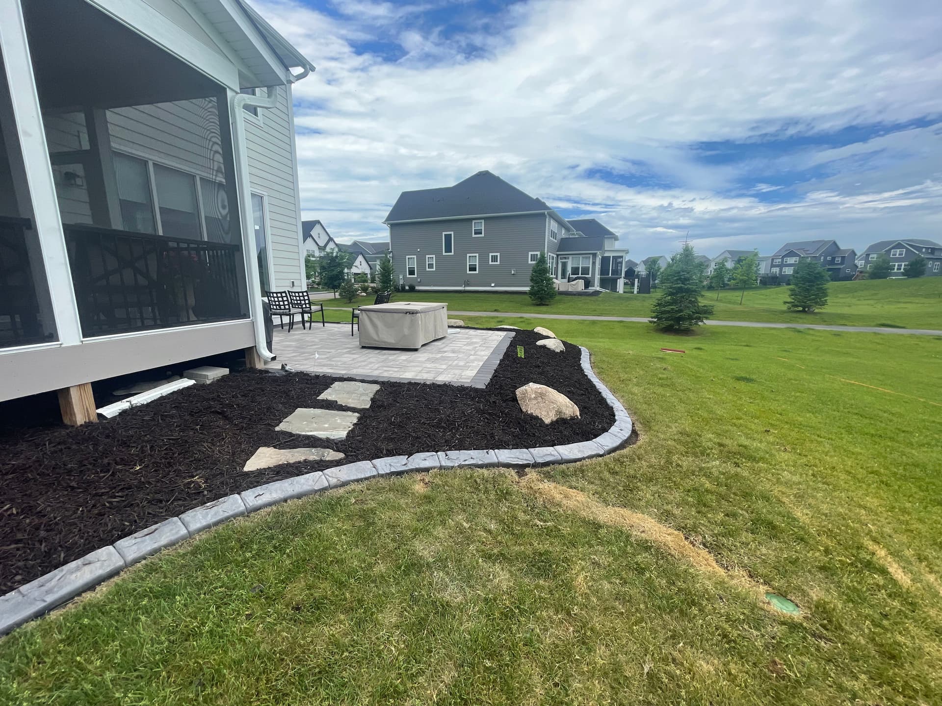 Gallery photos for Paver Patio with Fieldstone Boulders and Concrete Curb Edging: Image #1