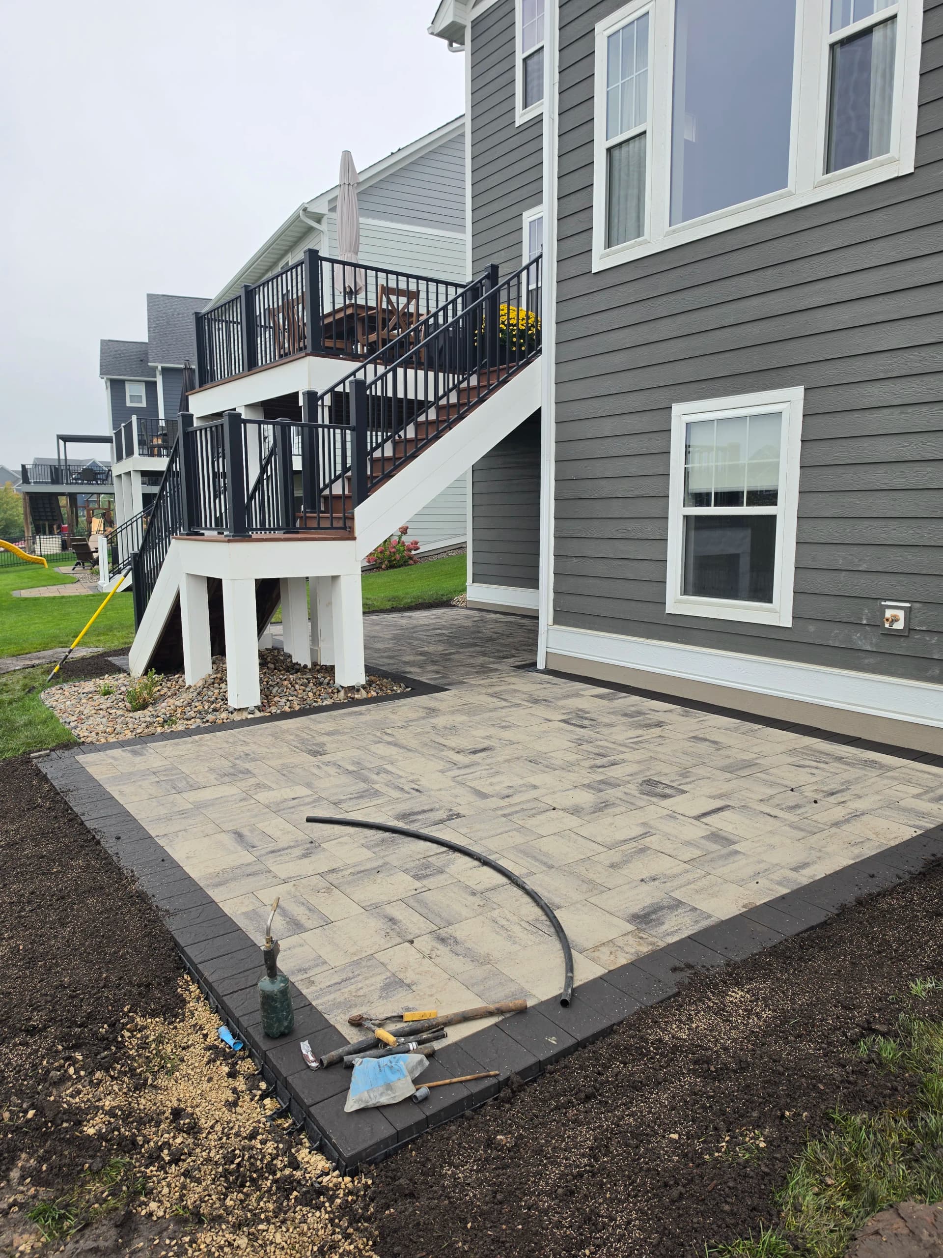 Gallery photos for Paver Patio Installation Around Existing Deck Stairs: Image #1