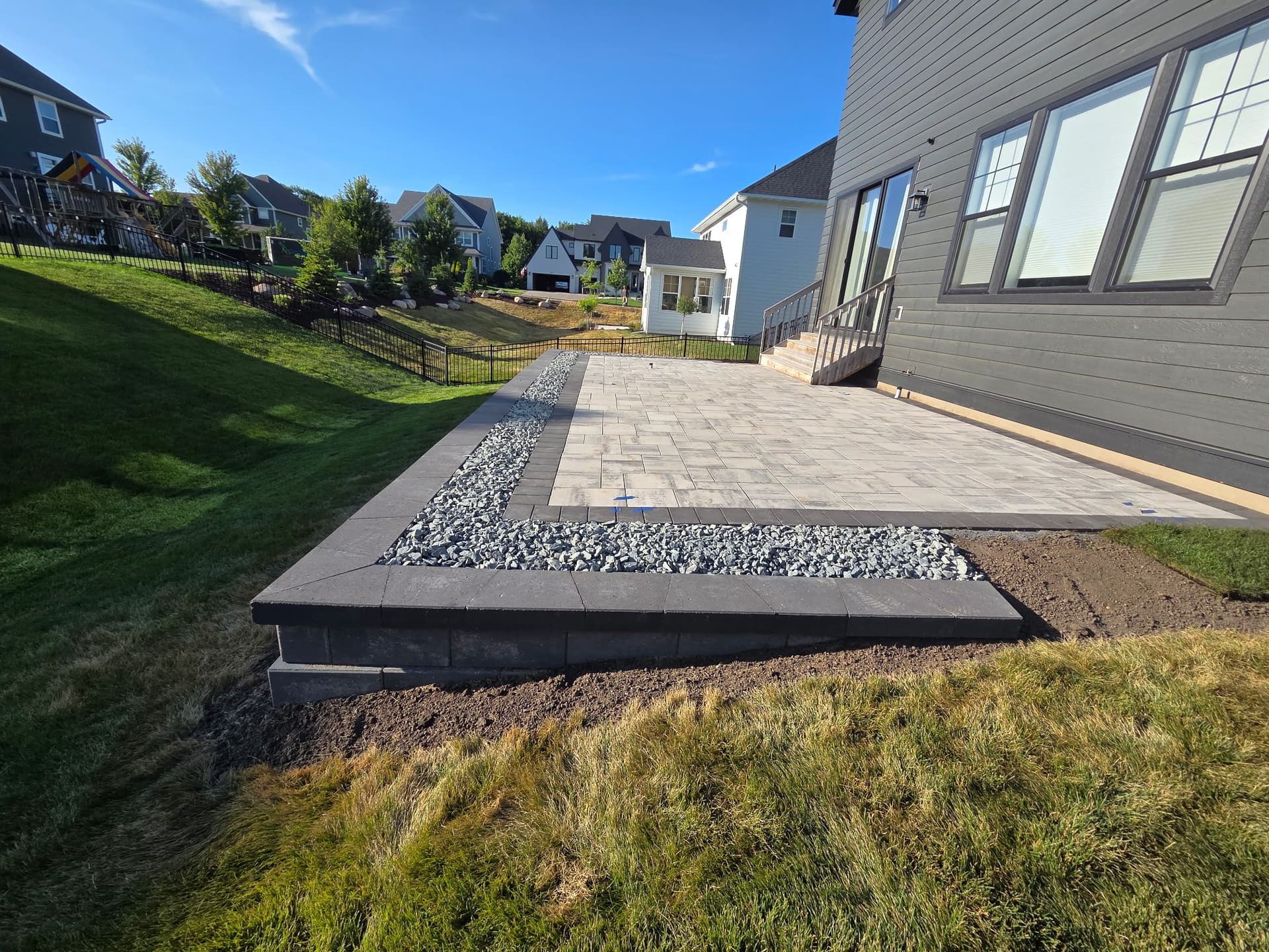How a Retaining Wall Turns a Sloped Yard Into a Real Patio image