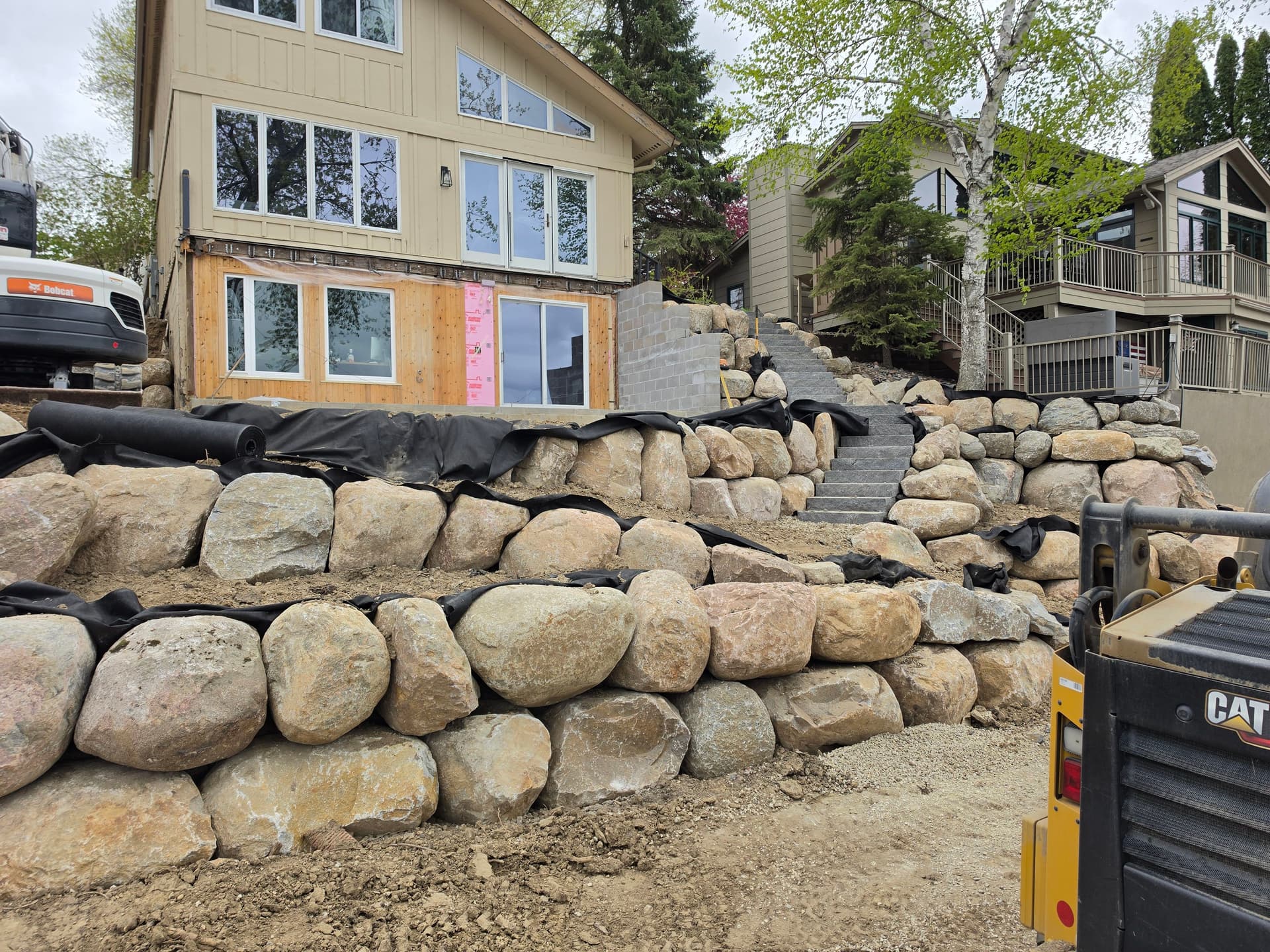 Boulder Retaining Wall and Steps Taking Shape in Prior Lake image