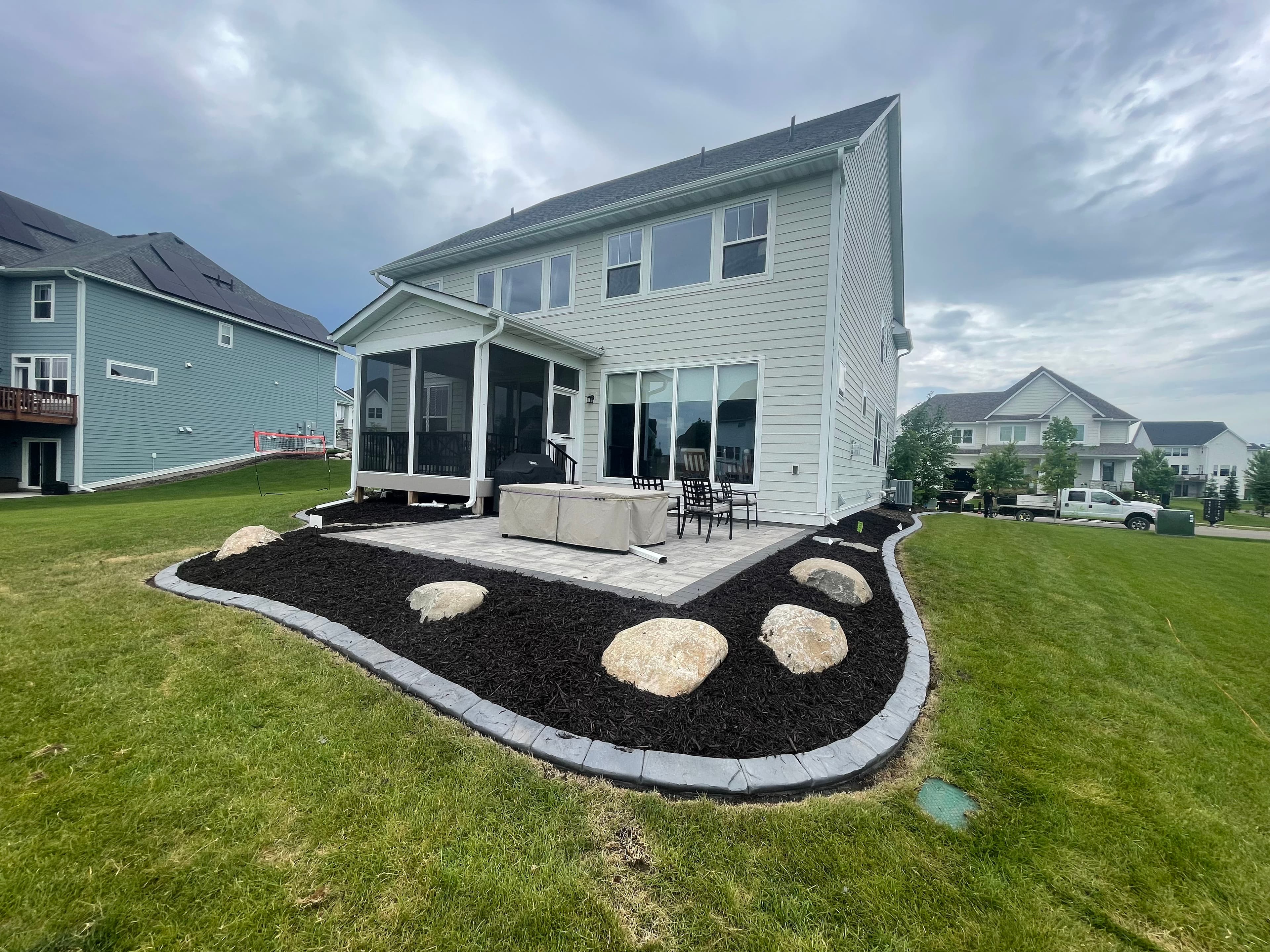Project Paver Patio with Fieldstone Boulders and Concrete Curb Edging image