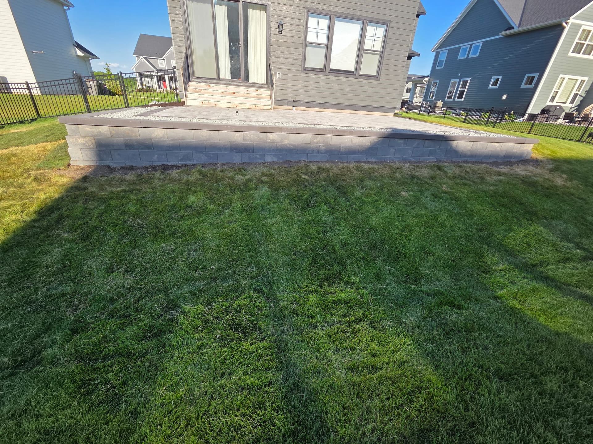 Gallery photos for How a Retaining Wall Turns a Sloped Yard Into a Real Patio: Image #1