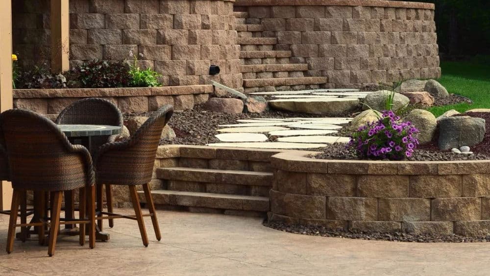 Stylish patio with stone steps, flower beds, and outdoor seating area for relaxation.